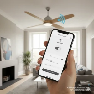 A hand holding a smartphone to control a smart ceiling fan via an app, compatible with UK smart home systems.