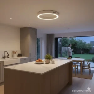 A modern bladeless ceiling fan with an integrated light ring installed over a kitchen island in an open-plan British kitchen-diner.