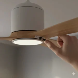 Close-up of the manual reverse toggle switch located on the motor housing of a UK-standard ceiling fan.