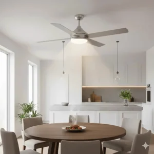 A brushed chrome ceiling fan with colour changing light positioned over a dining table in an open-plan kitchen.