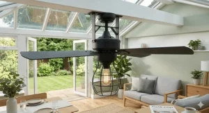 Matt black industrial-style conservatory ceiling fan with light in a contemporary grey-framed glass extension.