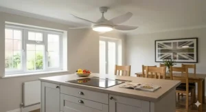 White low ceiling fan with integrated LED light installed over a kitchen breakfast bar in a modern UK kitchen-diner.