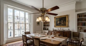 A classic 5-blade ceiling fan with light centred above a wooden dining table and chairs.