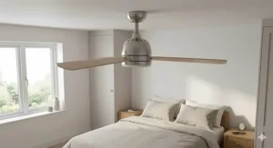 A photorealistic 4K image of a modern low-profile quiet remote control ceiling fan with timber blades, flush-mounted to a lower ceiling in a compact bedroom of a UK home.