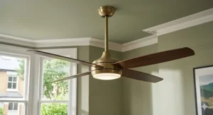 Close-up of a brushed brass ceiling fan adding a sophisticated touch to a dining room ceiling.