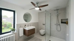 A polished chrome ceiling fan with dark wood blades complementing matching chrome towel rails and taps in a modern master ensuite.