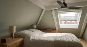 Diagram illustrating clockwise ceiling fan rotation to recirculate trapped warm air during British winter months.