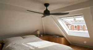 Two matching minimalist ceiling fans zoning the lounge and office areas of a large open-plan attic conversion.