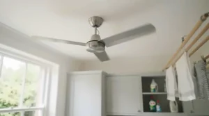 Low-profile ceiling fan circulating air in a compact utility room.