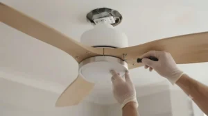 Diagram comparing the vertical clearance of a hugger fan versus a traditional downrod ceiling fan.