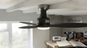 Weather-resistant damp-rated ceiling fan installed in an uninsulated, drafty British garage.