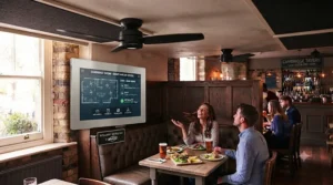 Brass-finish traditional ceiling fans complementing the heritage decor of a classic British pub dining area.