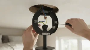 Step-by-step assembly view showing the secure hanging bracket for installing a bedroom ceiling fan.