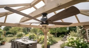 Illuminated gazebo ceiling fan casting a warm, ambient glow over an outdoor seating area at dusk.