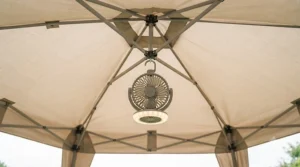 A hanging gazebo fan featuring an integrated LED light for evening outdoor gatherings.