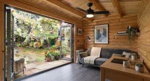 Close-up view of a professional electrician wiring a ceiling fan inside a newly built garden room.