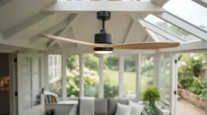 Stylish waterproof ceiling fan installed in a bright British conservatory with garden views.
