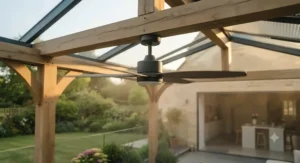 Outdoor ceiling fan operating on reverse setting to redistribute trapped warm air under a sheltered pergola.