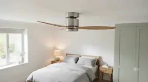 Sleek brushed chrome variable-speed DC ceiling fan fitted flush in a modern UK bedroom with low ceilings.