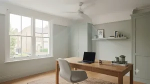 Sleek white reversible ceiling fan operating quietly in a modern home office setup.