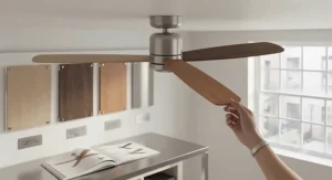 Stylish low wattage ceiling fan with natural wooden blades complementing a modern British home interior.