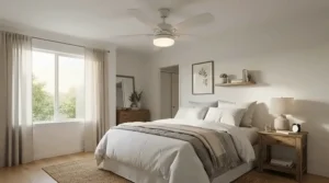 Quiet brushed nickel ceiling fan with light for low ceiling fitted in a compact master bedroom with fitted wardrobes.